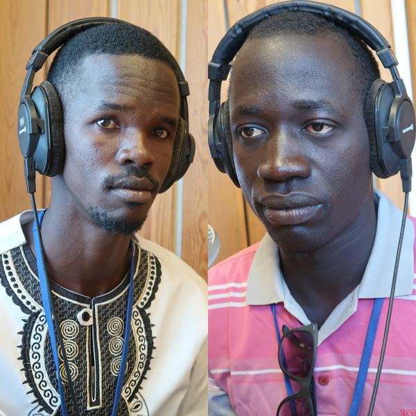 Two men wearing headphones in a radio studio